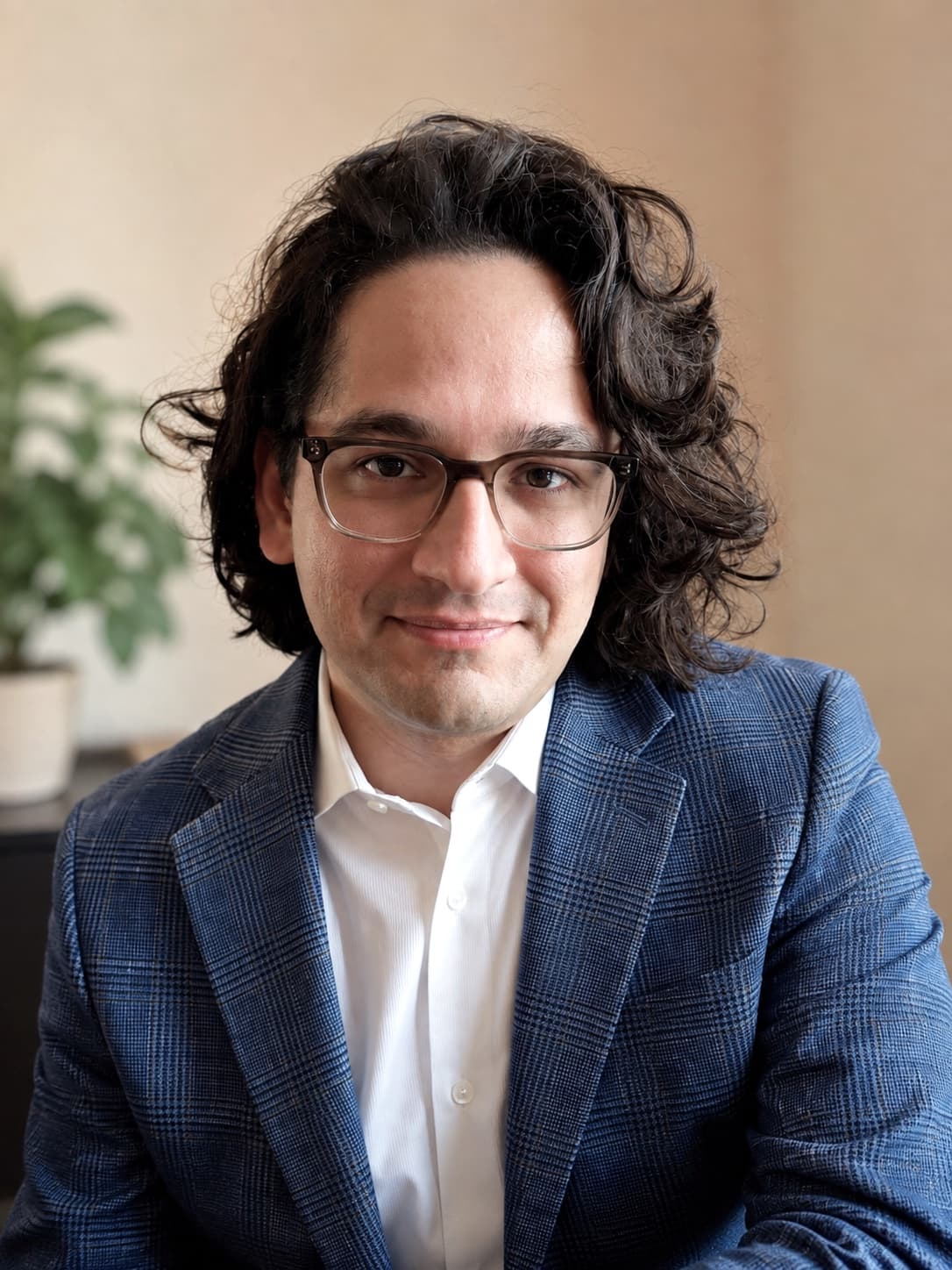 Alireza Ehteshami, Ph.D., wearing glasses and a blue blazer